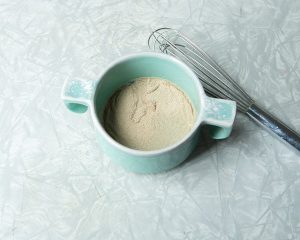 yeast sitting on top of water in bowl with whisk