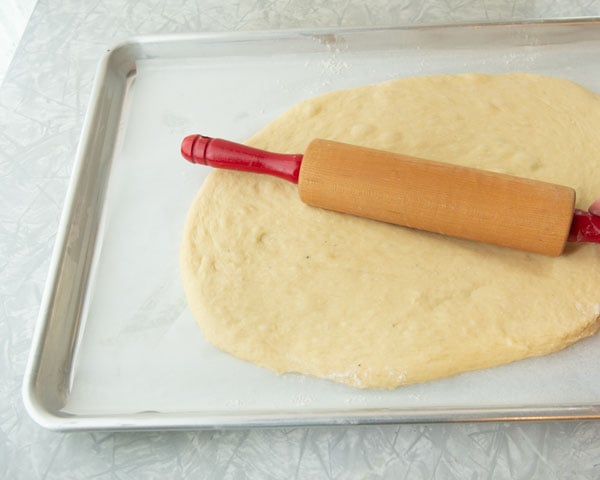 rolling dough into a pan