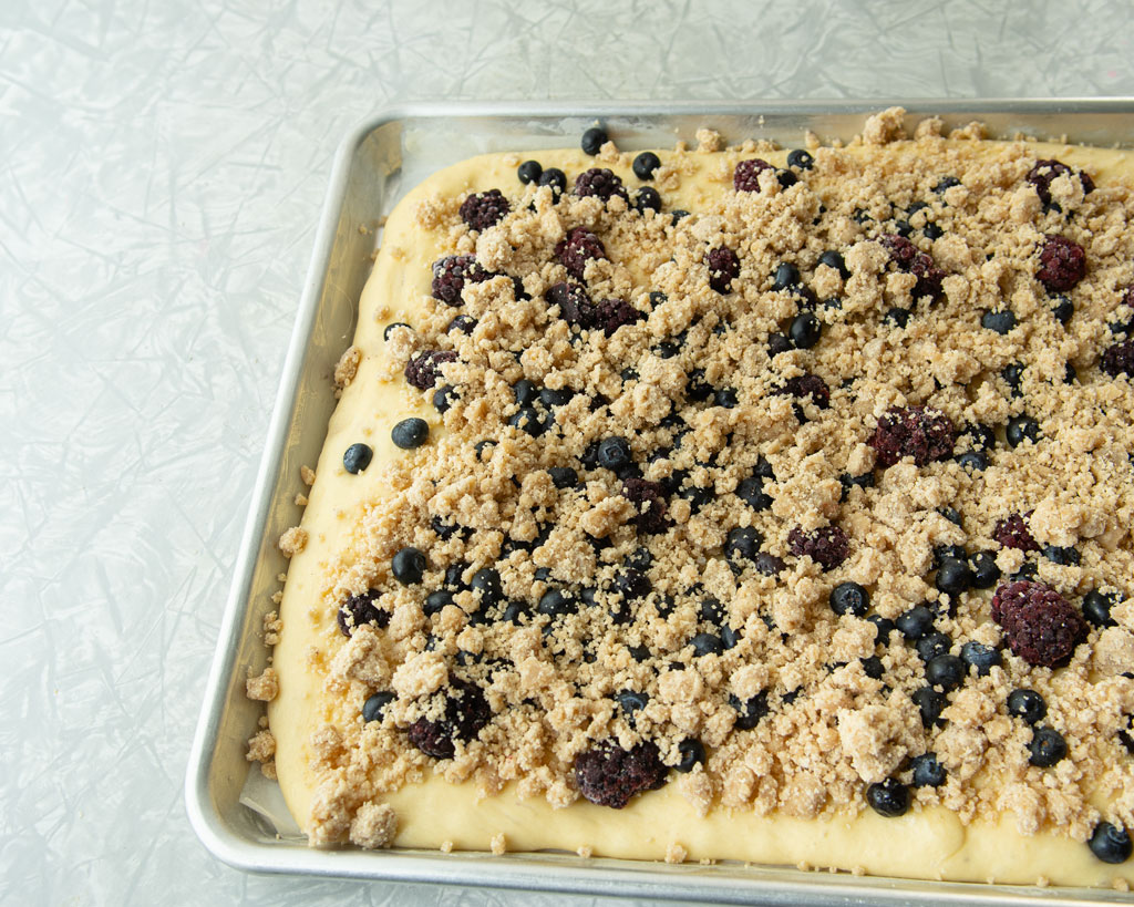 berries and streusel on top of dough