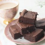 close up of stack of brownies with coffee