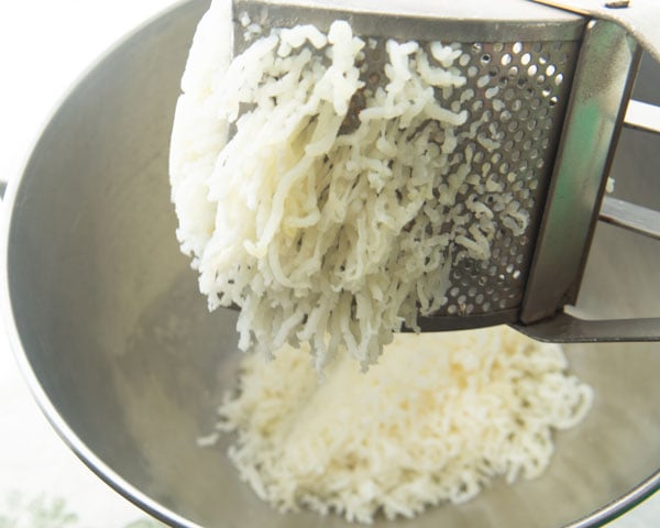 pressing potato in potato ricer