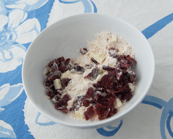 oatmeal, flour, white chocolate and cranberries in bowl