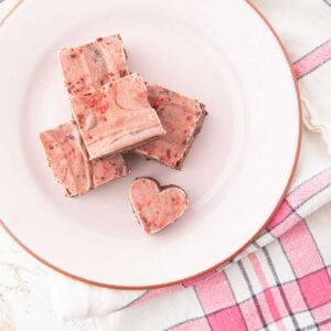 stack of black bean brownies covered with raspberry white chocolate, one cut like a heart
