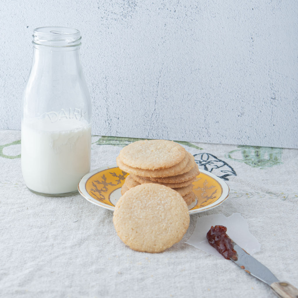 whole wheat butter cookies, jam on knife and milk bottle