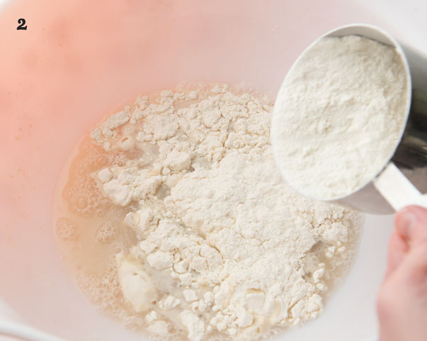 adding flour to yeast mixture