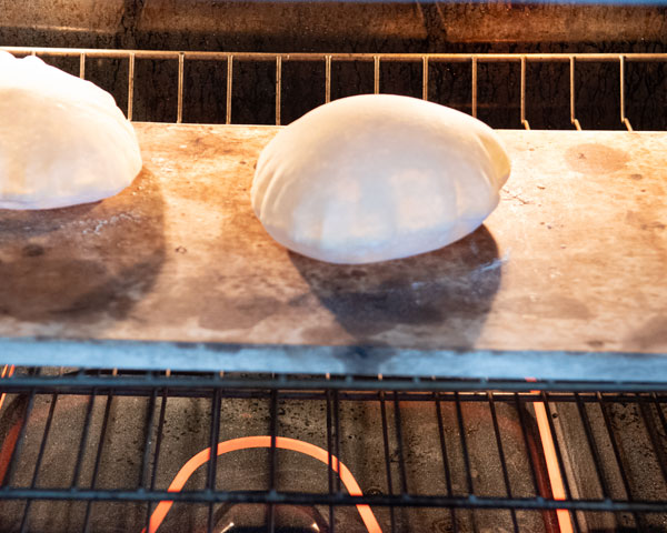 pita breads on pizza stone after baking
