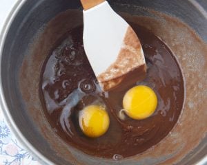 mixing eggs into brownie batter