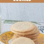 stack of whole wheat butter cookies on plate next to milk, text overlay
