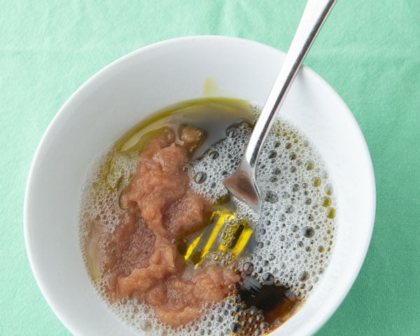 homemade granola liquid ingredients in bowl with fork