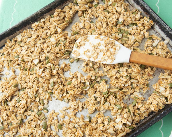 applesauce granola on sheet tray with spatula