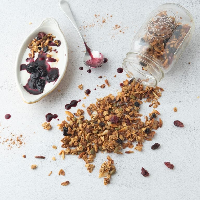 applesauce granola, jar, spoon, cup of blueberry yogurt