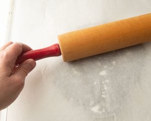 rolling cookie dough between parchment