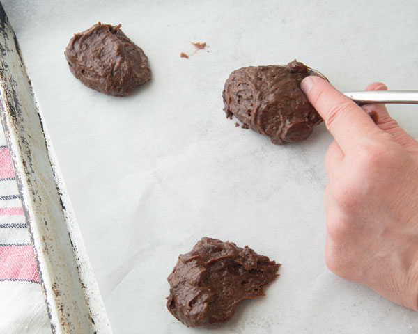 scooping out chocolate drop cookie batter