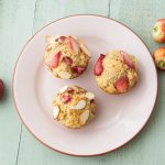 strawberry yogurt muffins on plate with strawberries