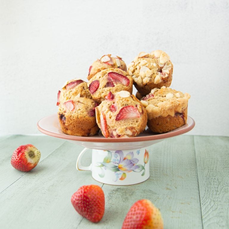 whole wheat strawberry yogurt muffins on plate with strawberries