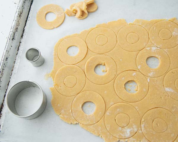 cutting out rings from butter cookie dough