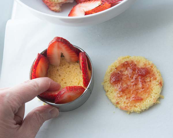Lining biscuit cutter ring with strawberries