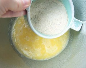 adding yeast mixture to milk and butter