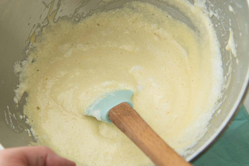 folding beaten egg whites and yolks together with mascarpone