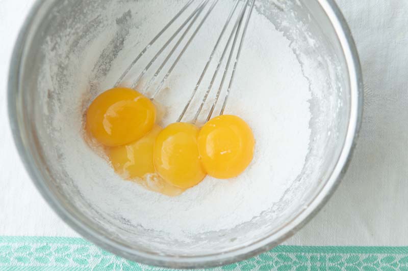 adding egg yolks to starch and sugar