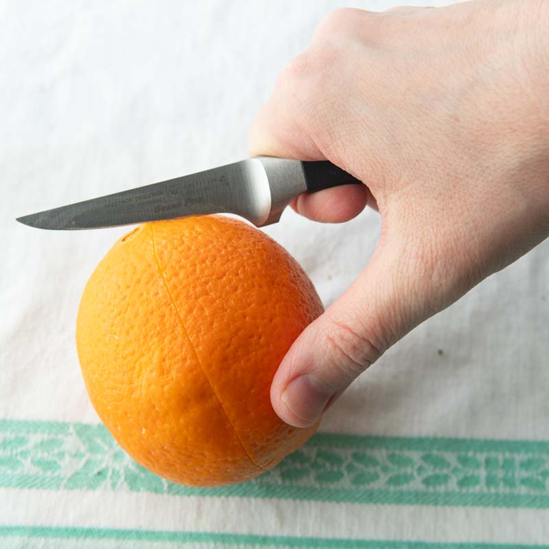 scoring orange peel with knife