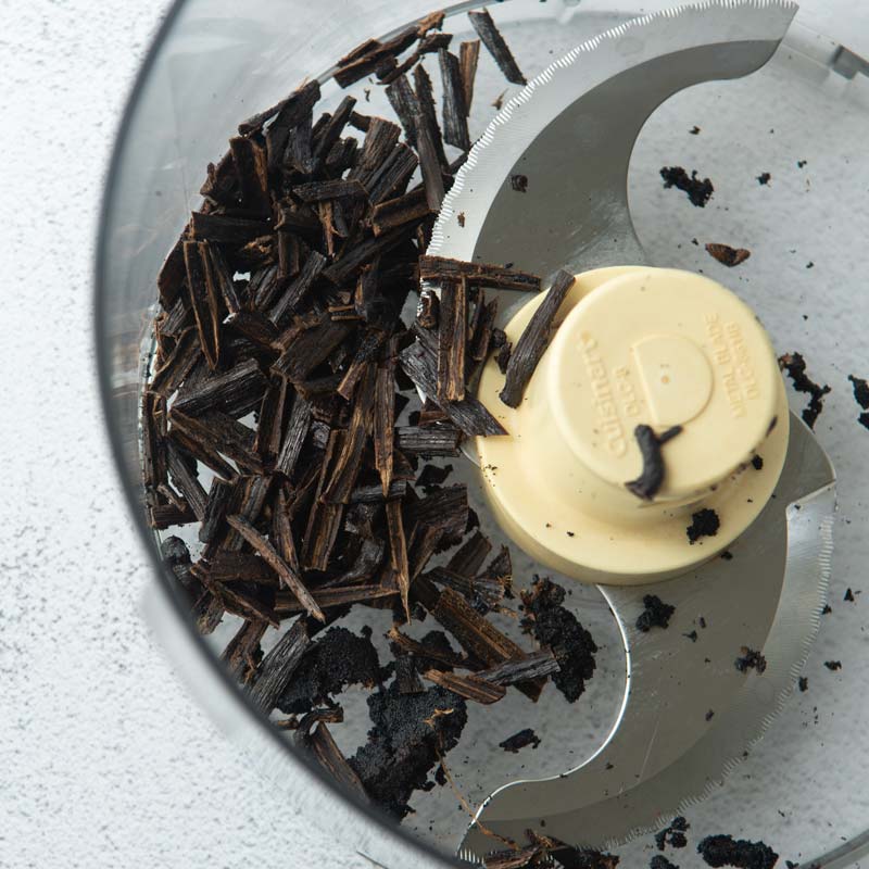 vanilla bean pod pieces in food processor bowl