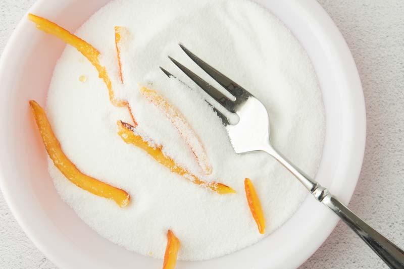 tossing candied orange in sugar