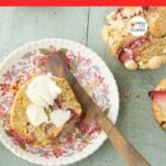 strawberry muffin on plate with butter and butter spreader, strawberry muffin just out of frame, text overlay