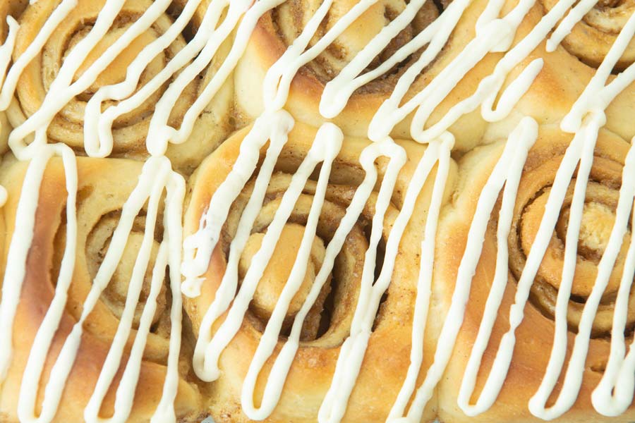 closeup of cinnamon rolls with cream cheese icing