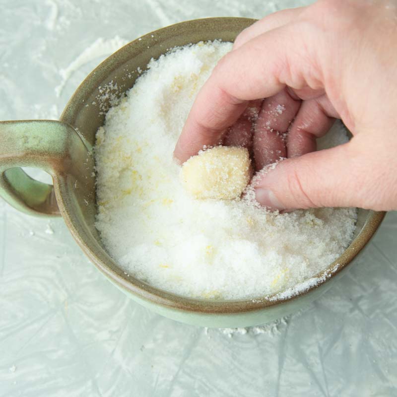 rolling dough in lemon sugar