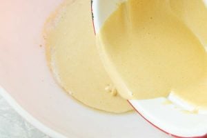 pouring eggs and sugar over browned butter