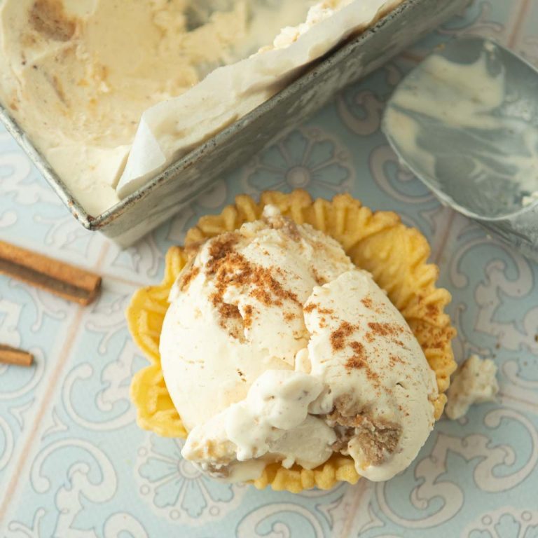 no-churn cinnamon ice cream in pizelle waffle cups, ice cream scoop, and loaf pan