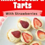 custard tartlets topped with strawberries on plate, text overlay
