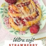strawberry jam roll on plate with strawberries