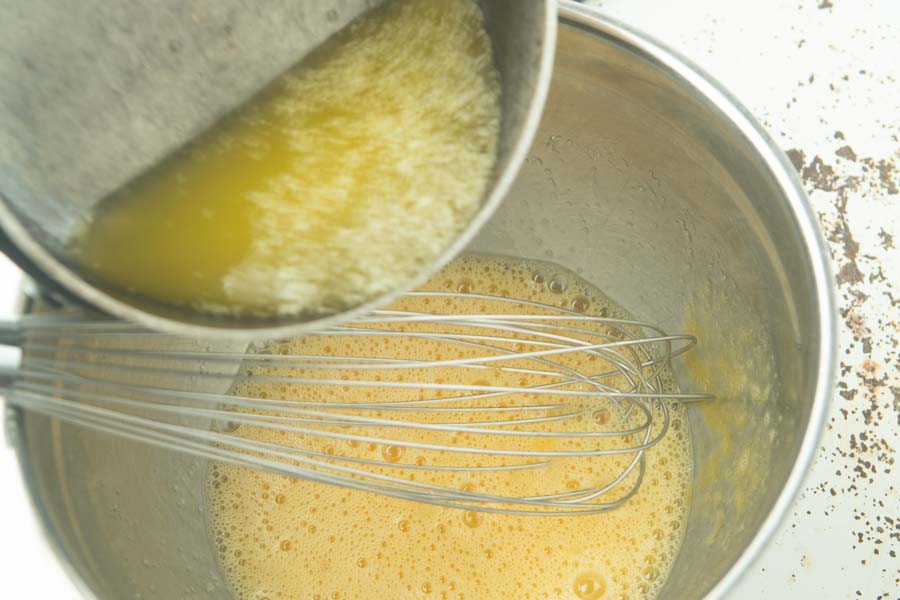 whisking butter into eggs