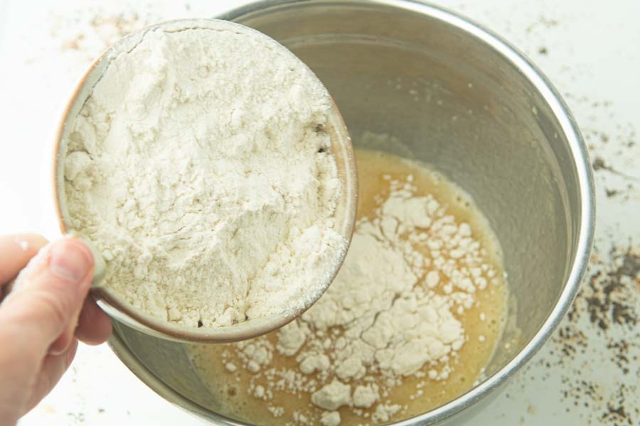 adding flour to eggs