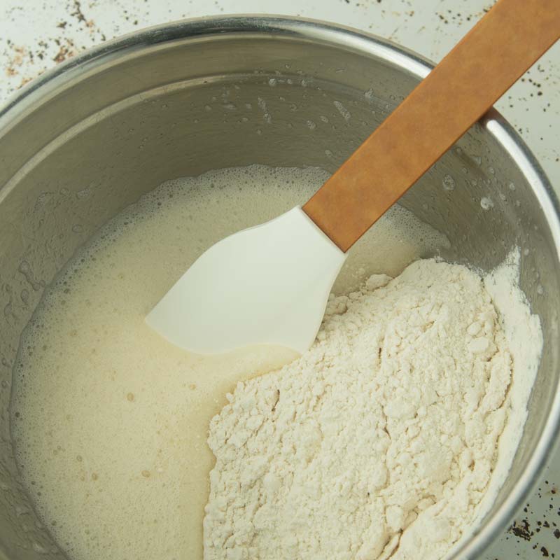 folding flour into eggs