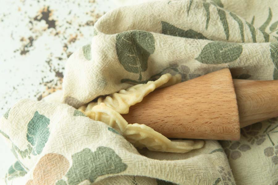 wrapping cooked pizzelle around cone form