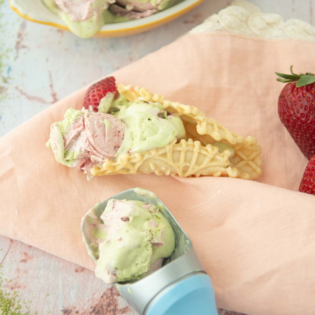 strawberry matcha no-churn ice cream in cone with scoop