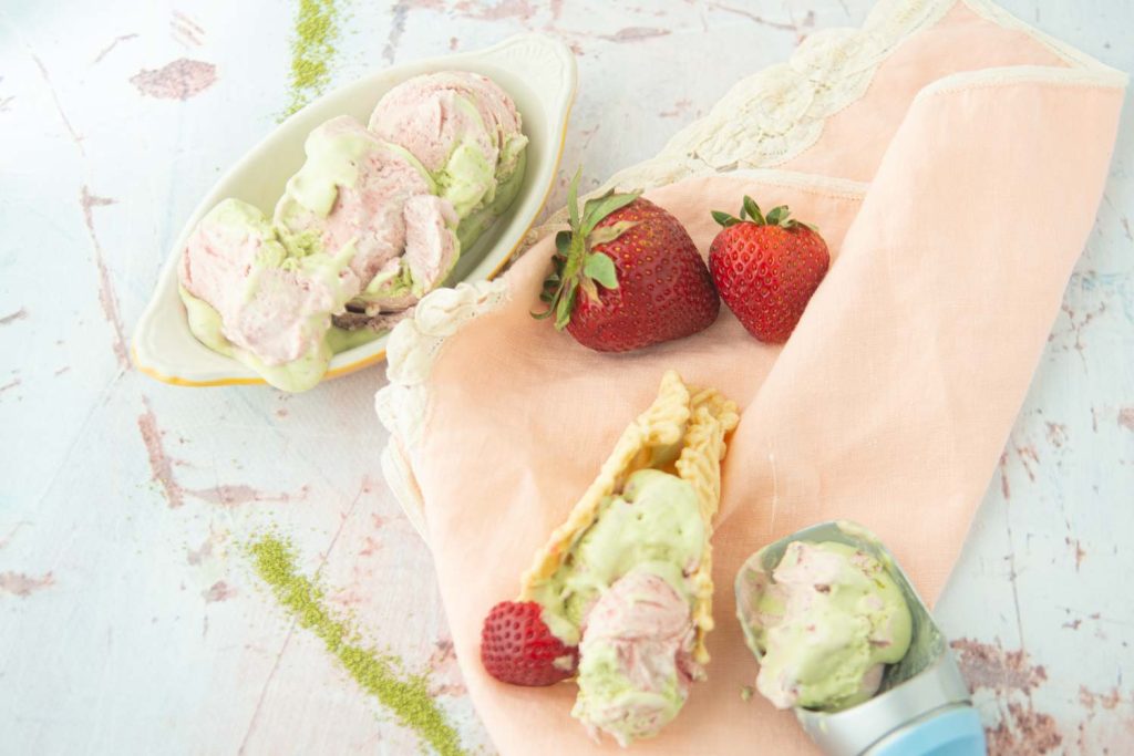 strawberry matcha no-churn ice cream with strawberries, cone, and scoop