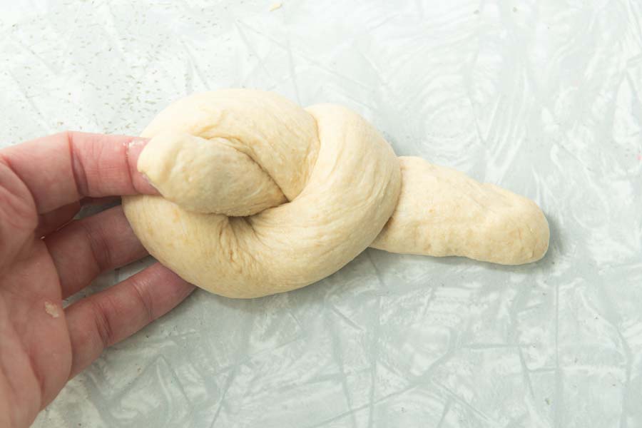 bringing end of dough through middle of a roll