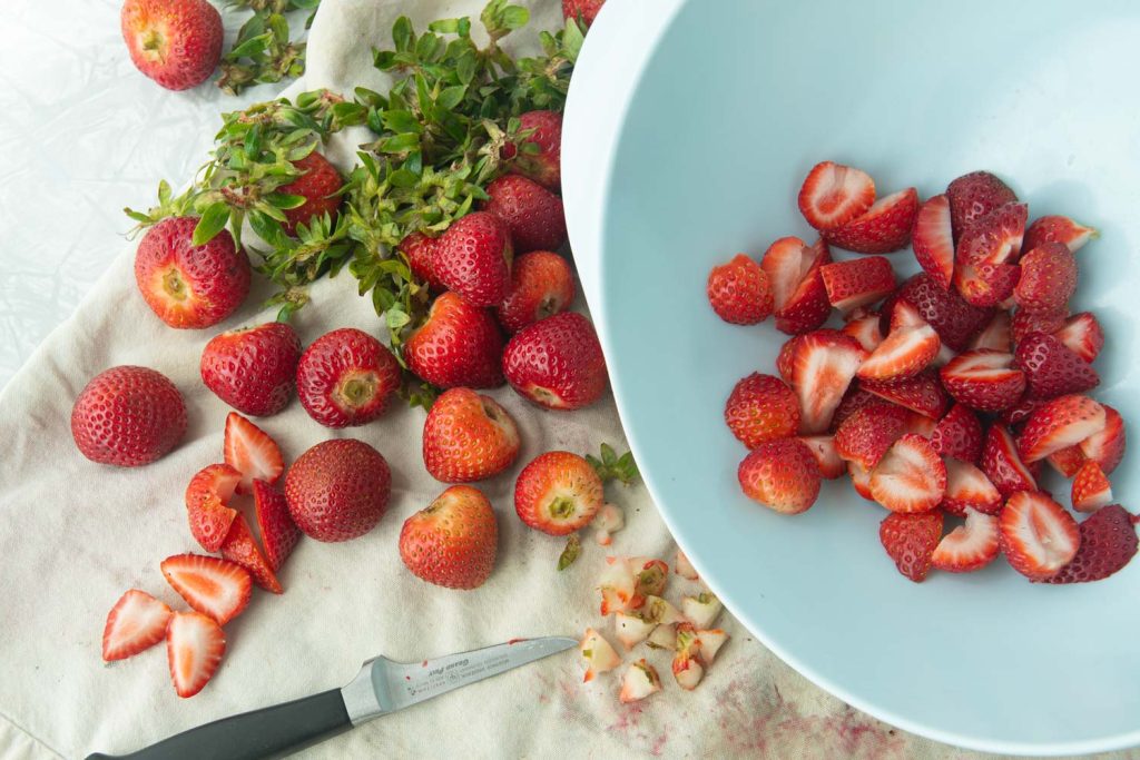 cutting up strawberries