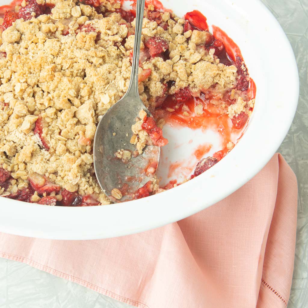 strawberry crisp in dish with spoon