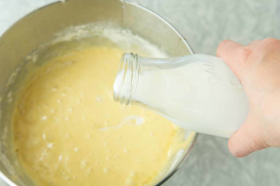 pouring milk into cake batter