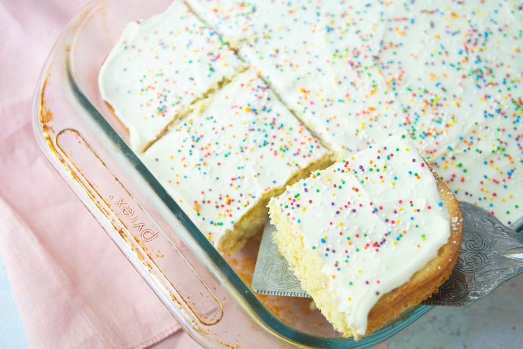 cut pieces of vanilla sheet cake in pan