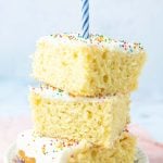 stacked pieces of vanilla sheet cake with birthday candle