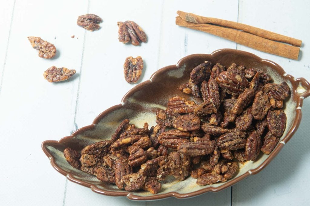 maple candied pecans in dish with cinnamon