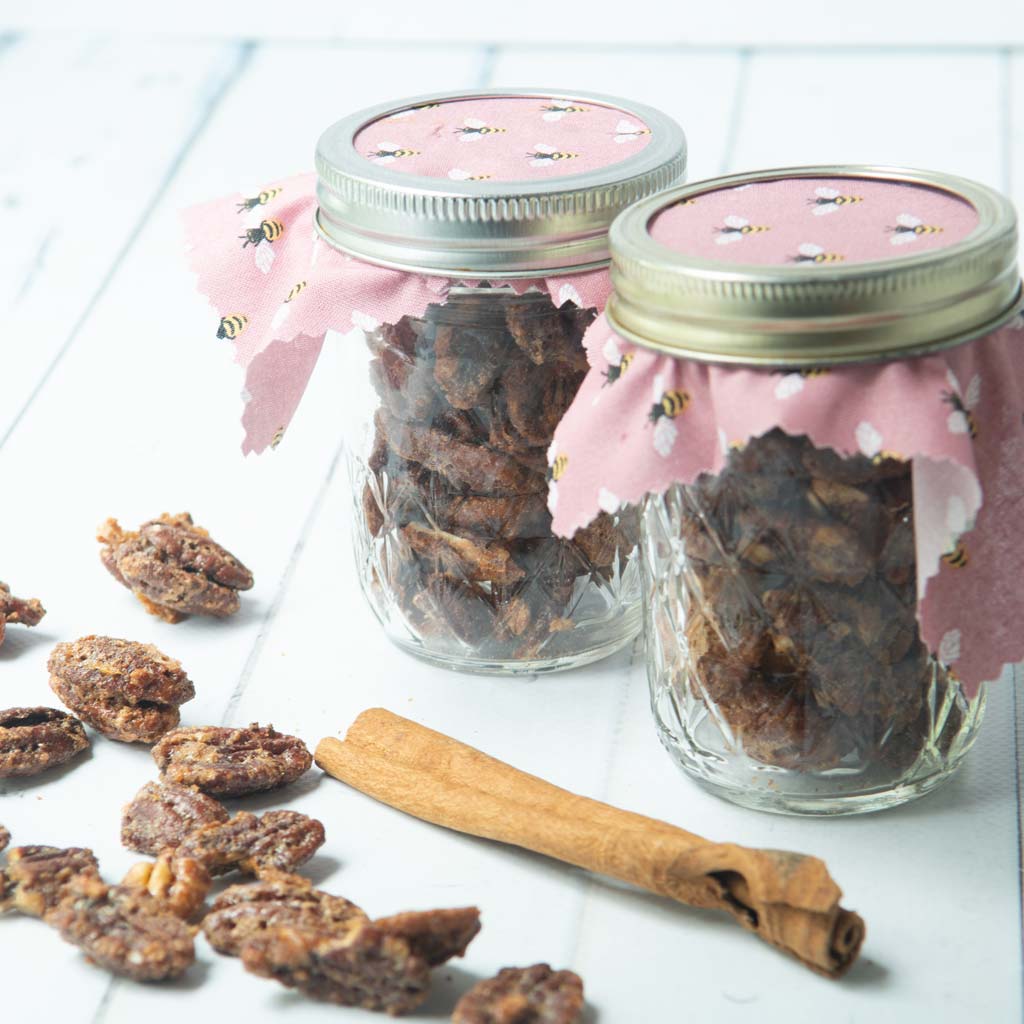candied maple pecans in jars with cinnamon