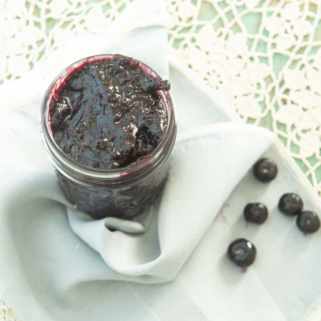 blueberry jam in jar with blueberries