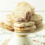 spiced pecan sandies cookies on plate with candied pecans